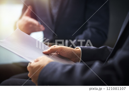 two asian corporate executives discussing business in office 121081107