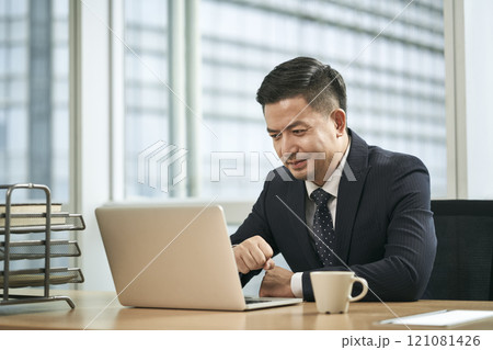asian business man working in office using laptop computer 121081426