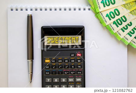 Investment symbol. Concept word Investment on beautiful black calculator. Beautiful white background. Euro bills. Black pen. Business investment concept. Copy space. 121082762