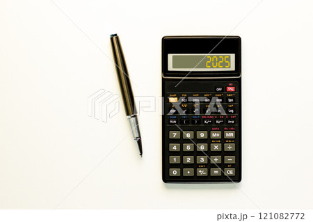 Business concept of 2025 new year symbol. Beautiful black calculator with number 2025. Beautiful white background, copy space. Beautiful black pen. Business 2025 happy new year concept. Business concept of 2025 new year symbol. Beautiful black calculator with number 2025. Beautiful white background, copy space. Beautiful black pen. Business 2025 happy new year concept. 121082772