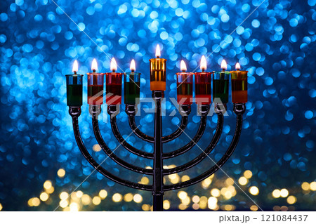 Hanukkah Menorah with burning candles on dark background with bokeh lights. 121084437