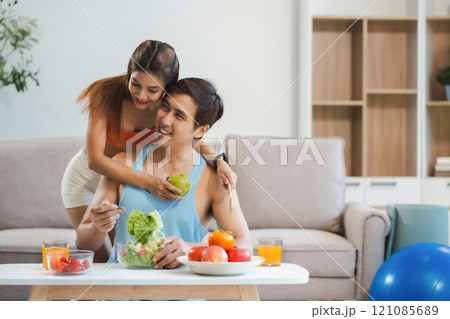 Fit Smiling couple enjoys healthy fruit breakfast. Fit Smiling couple enjoys healthy fruit breakfast. 121085689