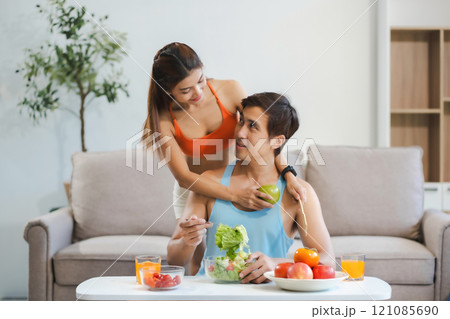 Fit Smiling couple enjoys healthy fruit breakfast. Fit Smiling couple enjoys healthy fruit breakfast. 121085690
