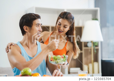 Fit Smiling couple enjoys healthy fruit breakfast. 121085704