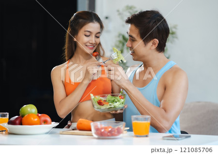 Fit Smiling couple enjoys healthy fruit breakfast. Fit Smiling couple enjoys healthy fruit breakfast. 121085706