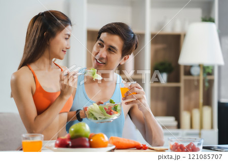Fit Smiling couple enjoys healthy fruit breakfast. Fit Smiling couple enjoys healthy fruit breakfast. 121085707