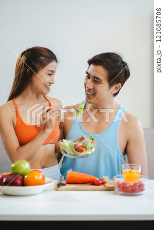 Fit Smiling couple enjoys healthy fruit breakfast. Fit Smiling couple enjoys healthy fruit breakfast. 121085708