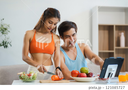 Fit Smiling couple enjoys healthy fruit breakfast. Fit Smiling couple enjoys healthy fruit breakfast. 121085727