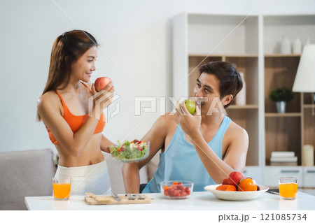 Fit Smiling couple enjoys healthy fruit breakfast. 121085734