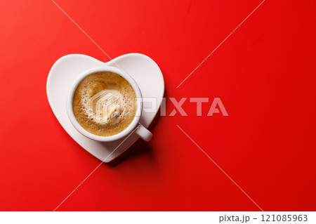 A charming coffee cup placed on a heart-shaped saucer A charming coffee cup placed on a heart-shaped saucer 121085963