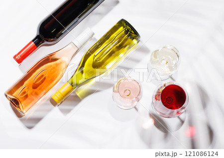 Three wine glasses filled with red, white, and rose wine Three wine glasses filled with red, white, and rose wine 121086124