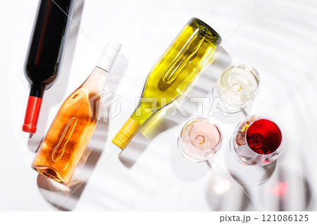 Three wine glasses filled with red, white, and rose wine 121086125