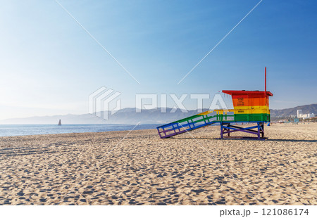Vibrant lifeguard tower painted in LGBTQ rainbow colors 121086174