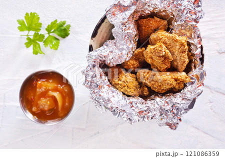Delicious chicken nuggets on white background 121086359
