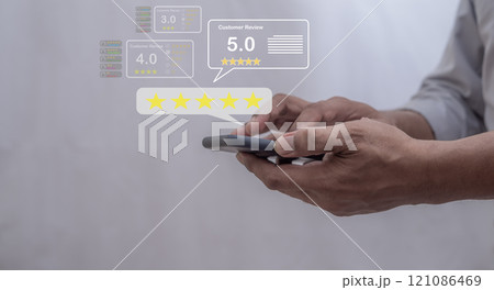 Customer Review, Young Man hand using smartphone mobile with five star to review and give 5 stars  121086469