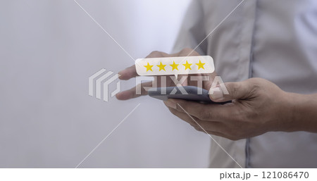 Customer Review, Young Man hand using smartphone mobile with five star to review and give 5 stars Customer Review, Young Man hand using smartphone mobile with five star to review and give 5 stars 121086470
