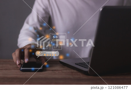 Customer Review, Young Man hand using Smart Phone and laptop with five star to review  121086477