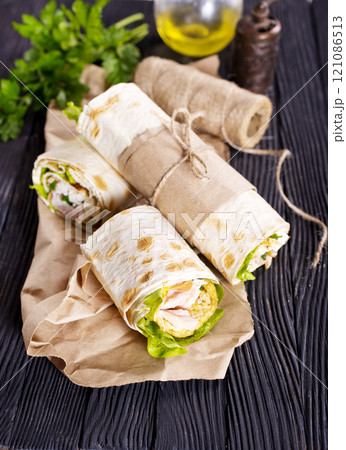 Shawarma sandwich, fresh roll of lavash (pita bread) pork shawarma with ham and cheese Shawarma sandwich, fresh roll of lavash (pita bread) pork shawarma with ham and cheese 121086513