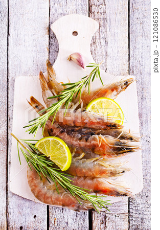 Uncooked Raw peeled tiger white shrimp prawn. Top view. Uncooked Raw peeled tiger white shrimp prawn. Top view. 121086530