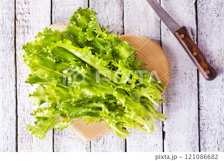 ripe organic green salad on a cutting board ripe organic green salad on a cutting board 121086682