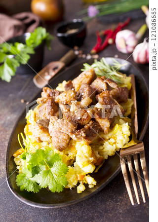 Uzbek food pilaf in iron pan. 121086685