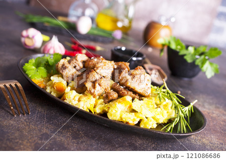 Uzbek food pilaf in iron pan. 121086686