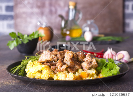 Uzbek food pilaf in iron pan. 121086687