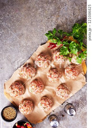 Raw meatball over beton ready for cooking 121086825