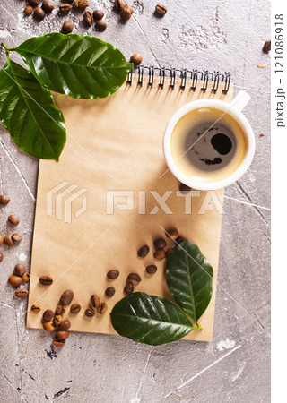 black coffee in coffee cup with coffee bean and on stone table 121086918