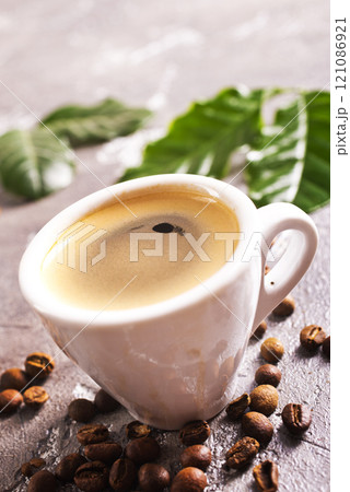 Coffee cup and beans on old kitchen table. Top view with copyspace for your text 121086921