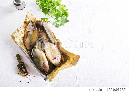 raw fish on wooden tray 121086985