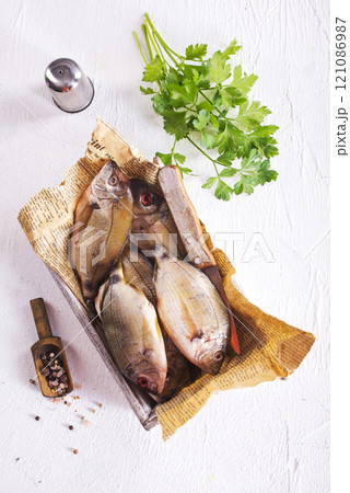 raw fish on wooden tray 121086987
