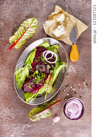salad from boiled beet on dark background. salad from boiled beet on dark background. 121087121