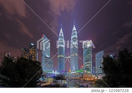 Night view of Kuala Lumpur's iconic skyline surrounded by modern skyscrapers and lights in summer 121087228