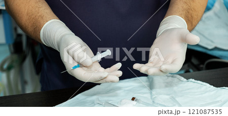 Syringe with medicine for intravenous administration in the hands of a doctor. Syringe with medicine for intravenous administration in the hands of a doctor. 121087535