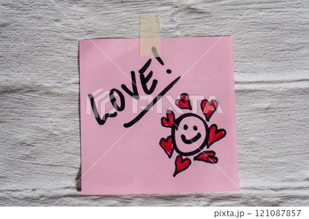 The word love written on a post-it or note. 121087857