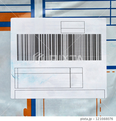 Barcode with adhesive label on blue and orange plastic shipping bag Barcode with adhesive label on blue and orange plastic shipping bag 121088076