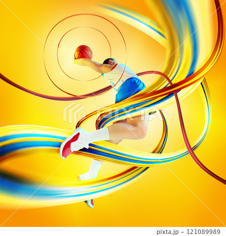 Contemporary art collage. Basketball player dunking with colorful ribbons swirling around against colorful yellow background Contemporary art collage. Basketball player dunking with colorful ribbons swirling around against colorful yellow background 121089989