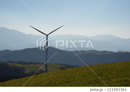 A huge wind turbine with beautiful nature as a background 121091361