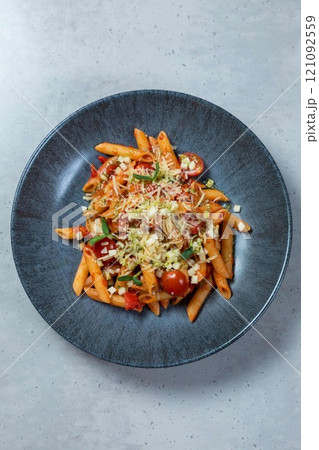 Penne pasta dish being served on modern restaurant table Penne pasta dish being served on modern restaurant table 121092559