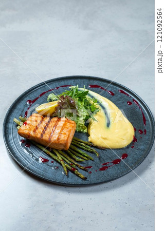 Grilled salmon with asparagus and mashed potatoes on modern restaurant menu 121092564