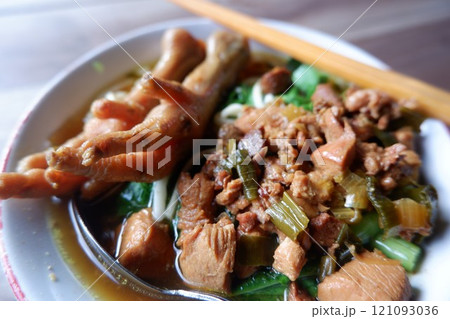 One bowl of traditional Indonesian chicken noodles. This food has a rich, spiced taste. 121093036
