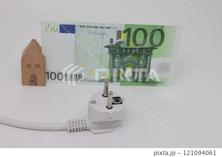 White electric cable and banknotes against the background of a toy model house White electric cable and banknotes against the background of a toy model house 121094061
