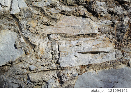 Closeup of ancient stone wall Background of rustic, rural building and masonry. Historic housing design concept of an urban structure outside with copyspace. Detail of antique architecture in village 121094141