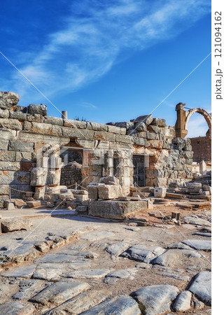 Ancient city ruins of Ephesus in Turkey in the day. Traveling abroad and overseas for holiday, vacation and tourism. Excavated remains of historical stone building from Turkish history and culture Ancient city ruins of Ephesus in Turkey in the day. Traveling abroad and overseas for holiday, vacation and tourism. Excavated remains of historical stone building from Turkish history and culture 121094162
