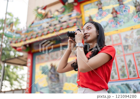 Celebrating chinese new year a photographer captures joyful moments in colorful environment with camera in community festivities Celebrating chinese new year a photographer captures joyful moments in colorful environment with camera in community festivities 121094280