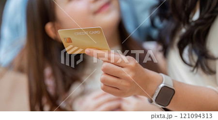Happy Family Enjoying Black Friday Shopping with Credit Card in Modern Retail Environment 121094313