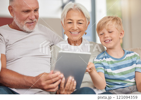 A happy mature couple bonding with their grandchild while babysitting and using a digital tablet on a couch at home. Grandparents relaxing with their cute little grandson and browsing the internet A happy mature couple bonding with their grandchild while babysitting and using a digital tablet on a couch at home. Grandparents relaxing with their cute little grandson and browsing the internet 121094359