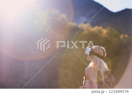 Earth, virtual reality and water with woman in nature for metaverse adventure, journey or travel. Forest, hiking and mountain with tourist person in VR headset for holiday or vacation user experience 121094574