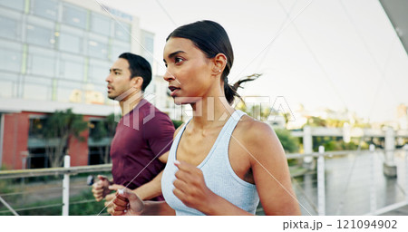 Interracial couple, exercise and running in city for workout, fitness or training together in urban town. Man, woman and athlete with cardio, sports or marathon for endurance and health or wellness 121094902